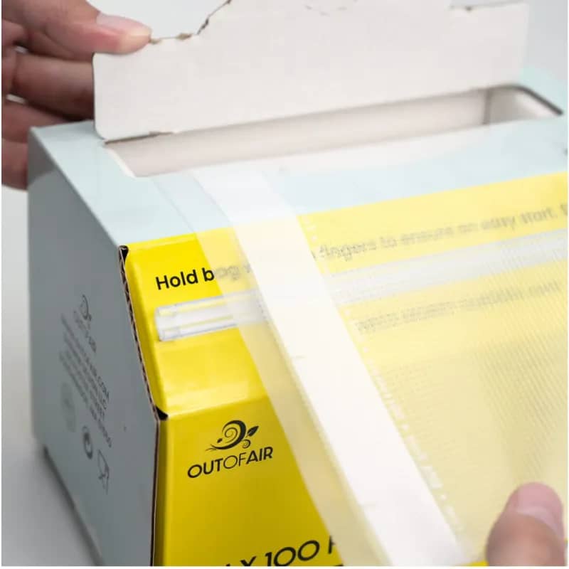 Vacuum sealer bag roll in a box with built-in cutter