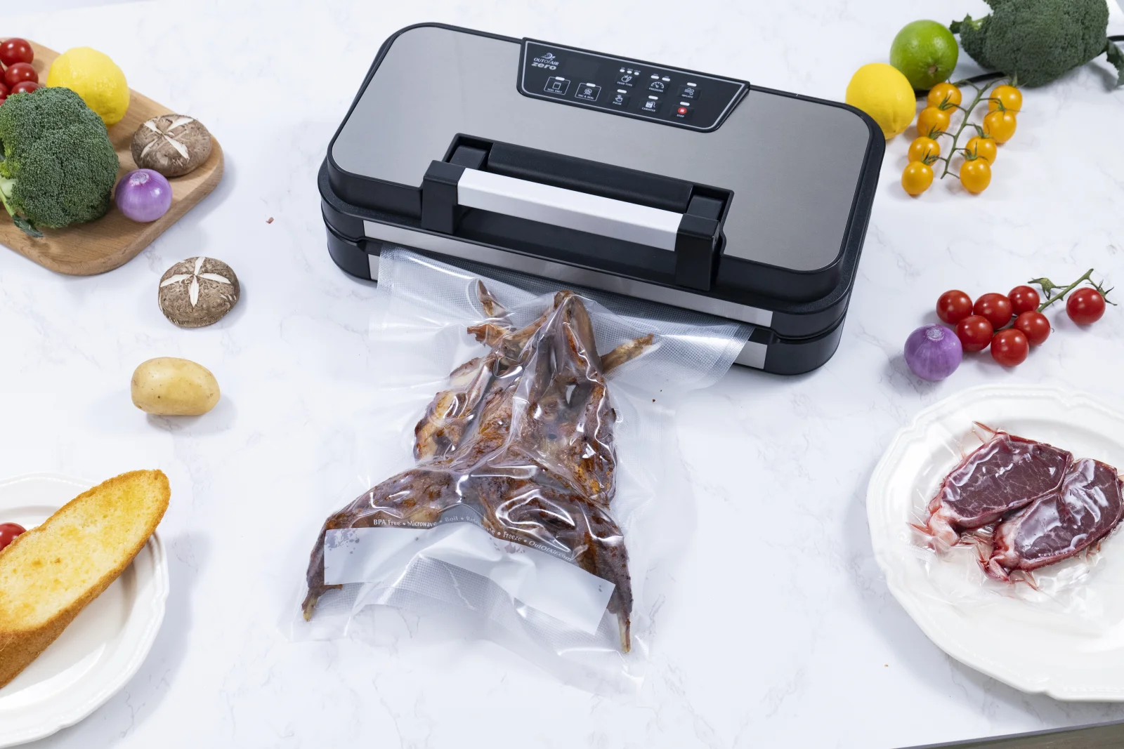 ZERO on a kitchen counter surrounded by fresh produce, bread and steak, with a sealed bag of fish